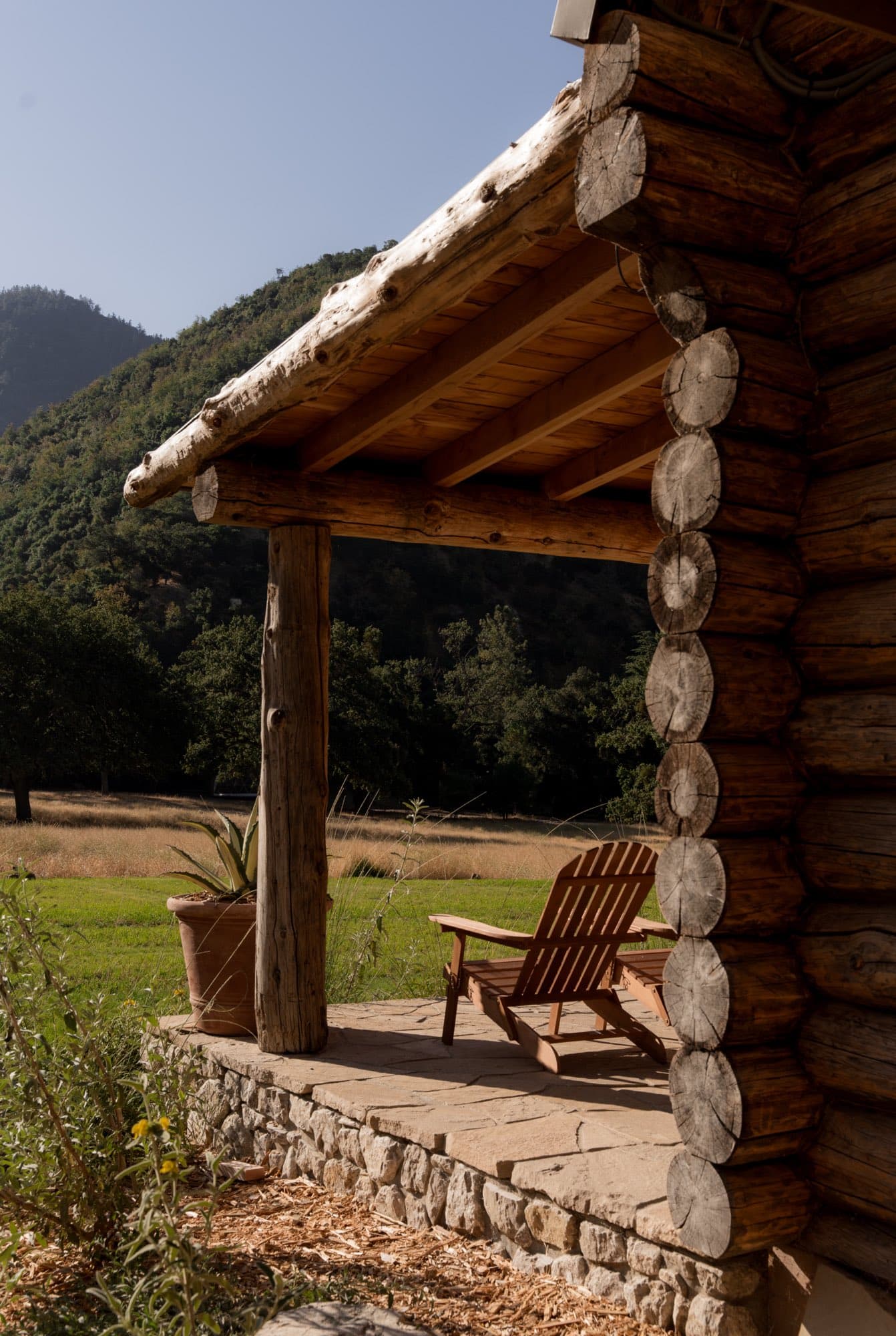 A cabin porch looking out over the meadow