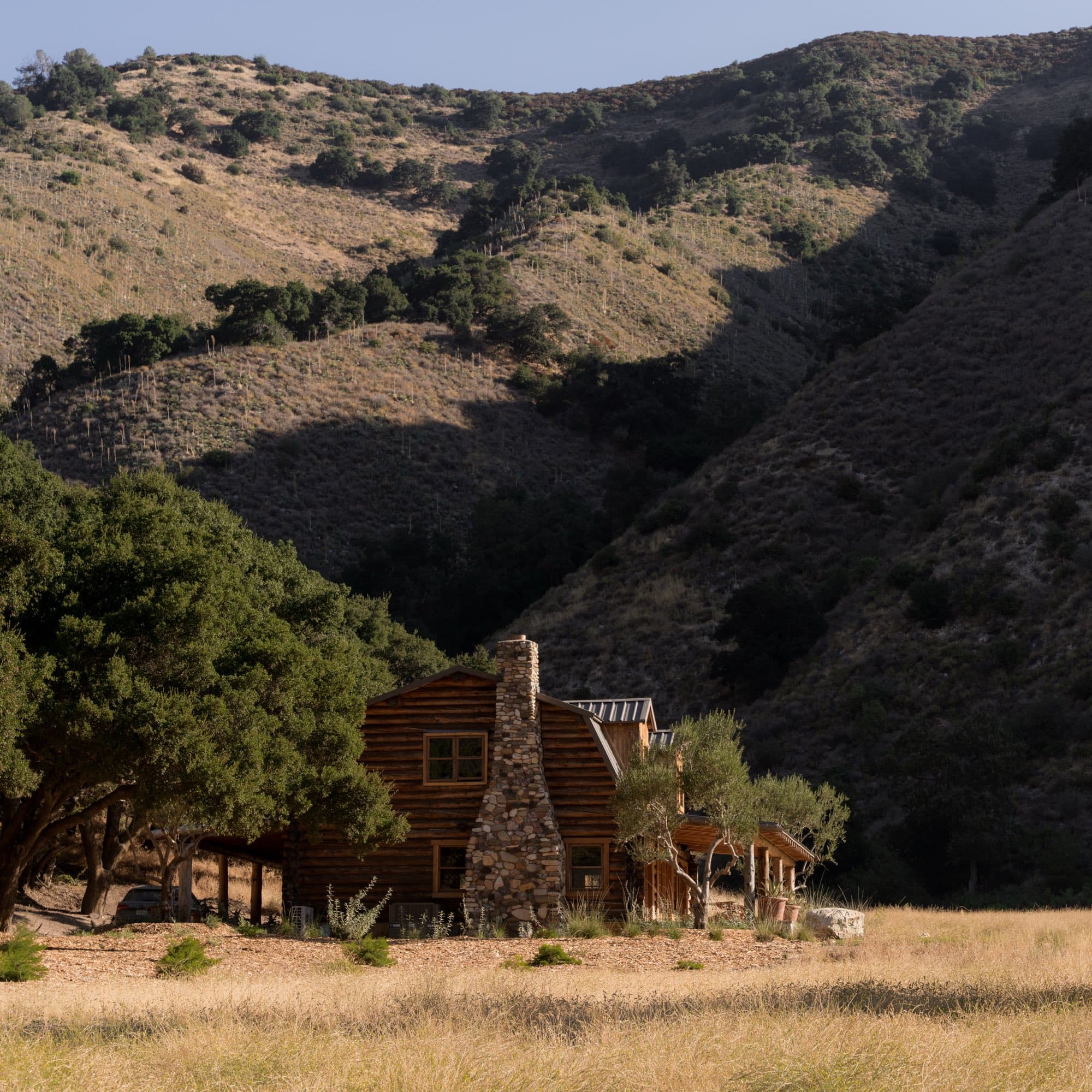 The Ranch House from the meadow, under the ridge